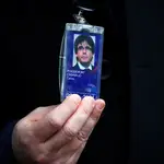 Former member of the Catalan government Carles Puigdemont shows his badge outside the European Parliament in Brussels, Belgium