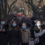 Visitors wearing face masks to help curb the spread of the coronavirus tour the Nanluoguxiang, the capital city's popular tourist spot on the fifth day of the Lunar Chinese New Year in Beijing, Tuesday, Feb. 16, 2021. (AP Photo/Andy Wong)