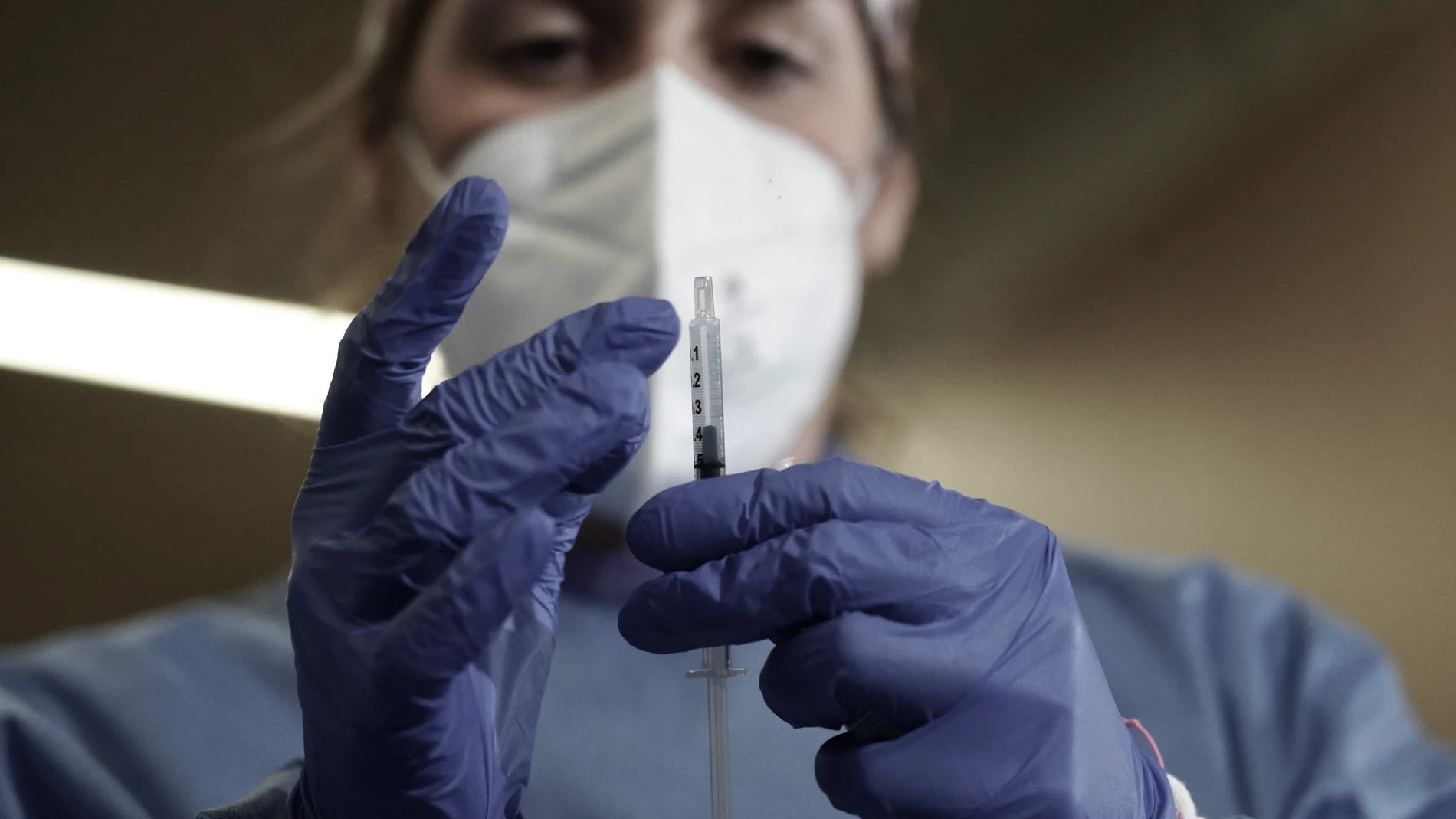 Una enfermera sostiene una jeringuilla con la vacuna contra la COVID-19 en un dispositivo instalado en la clínica IMQ de Zorrotzaurre, en Bilbao, País Vasco