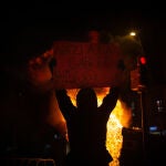 Uno de los manifestantes que apoyan a Pablo Hasel con una pancarta durante los disturbios en Barcelona (España), a 17 de febrero de 2021. David Zorrakino / Europa Press17/02/2021