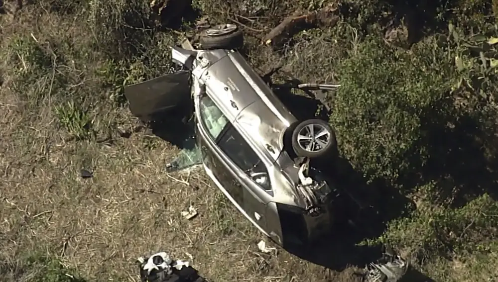 In this aerial image take from video provided by KABC-TV video, a vehicle rest on its side after a rollover accident involving golfer Tiger Woods along a road in the Rancho Palos Verdes section of Los Angeles on Tuesday, Feb. 23, 2021. Woods had to be extricated from the vehicle with the &quot;jaws of life&quot; tools, the Los Angeles County Sheriff's Department said in a statement. Woods was taken to the hospital with unspecified injuries. The vehicle sustained major damage, the sheriff's department said. (KABC-TV via AP)