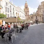 Varias personas disfrutan de las terrazas de la Plaza de Belluga en Murcia