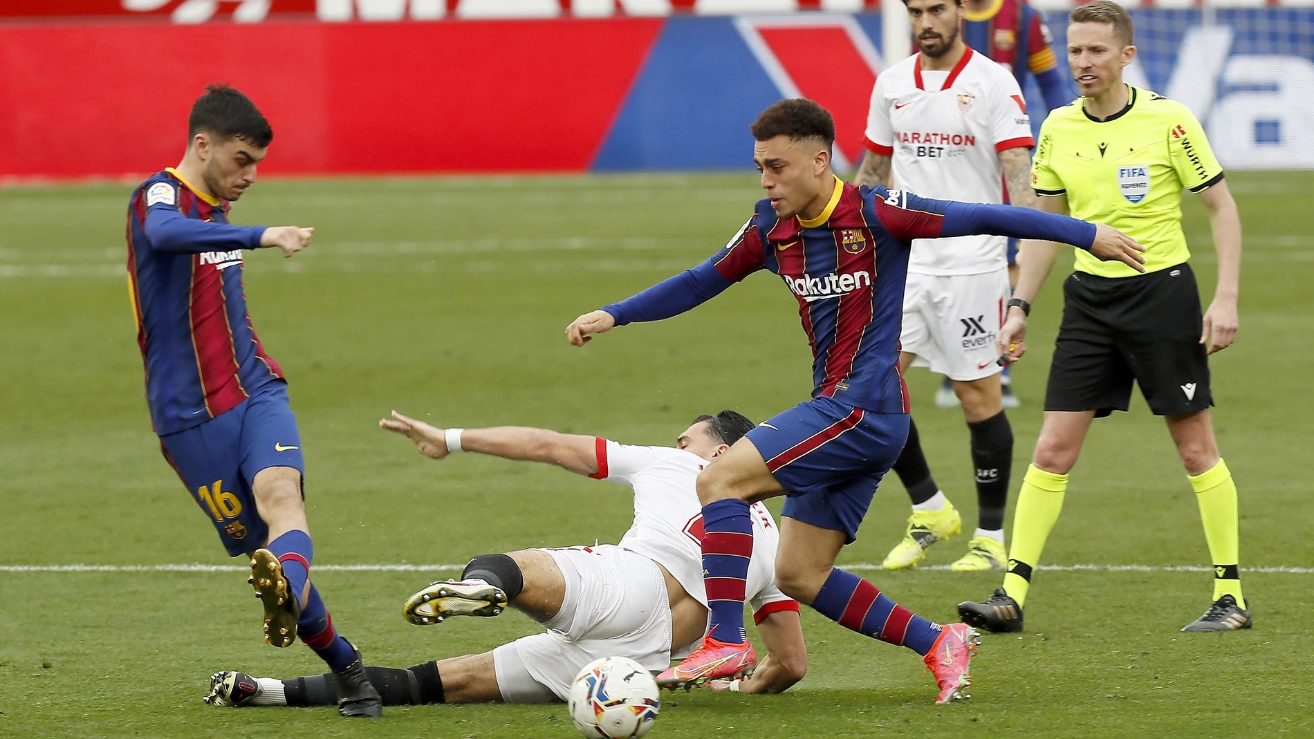 El sevillista Rekik pelea por un balón con Pedri y Dest