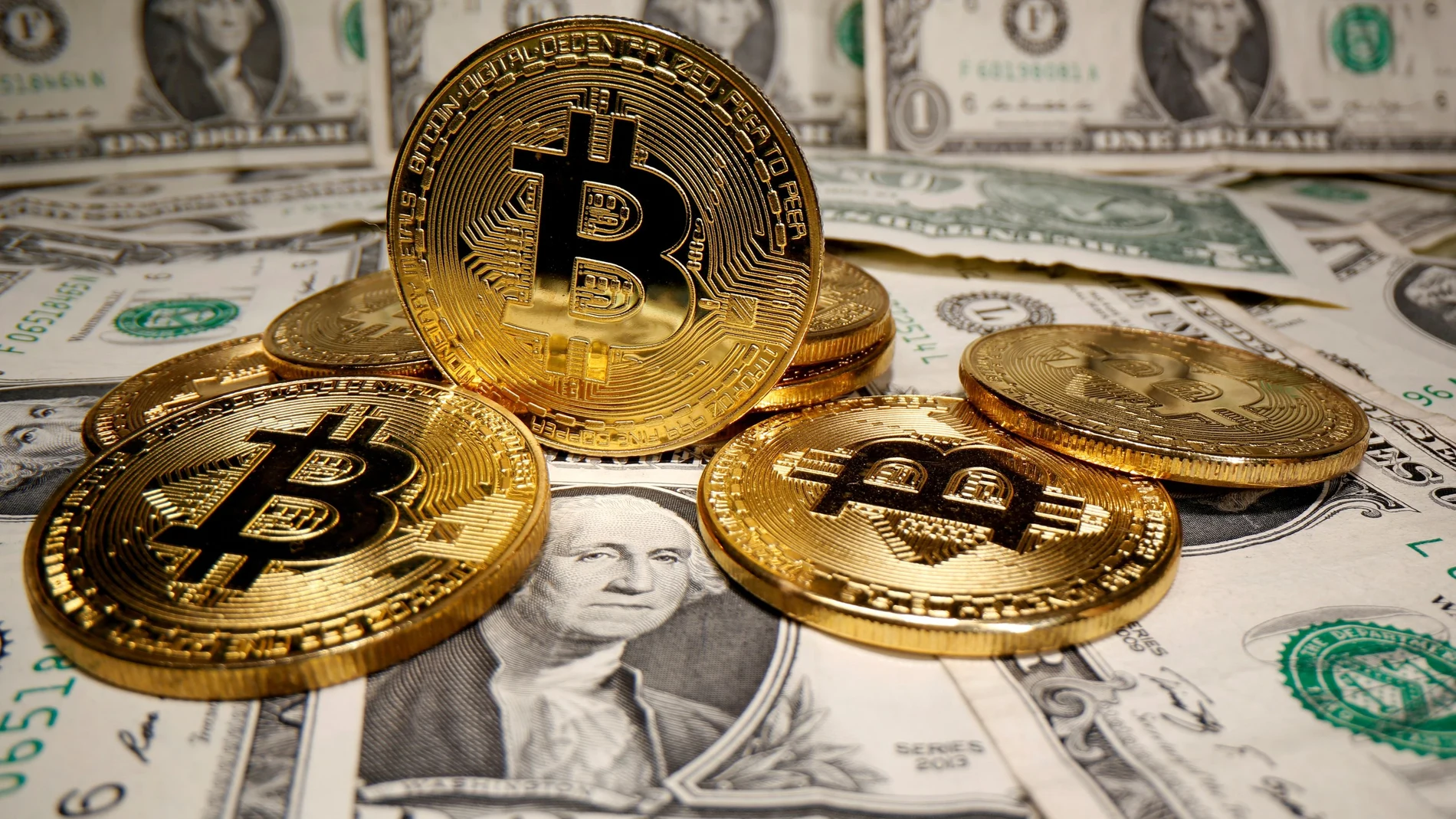 FILE PHOTO: Representations of virtual currency Bitcoin are placed on U.S. Dollar banknotes