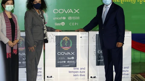 Cambodian Health Minister Mam Bun Heng, right, receives boxes of COVID-19 vaccines from World Health Organization (WHO) representative to Cambodia Dr. Li Ailan, left, Unicef country representative in Cambodia, EU Ambassador Carmen Moreno, center, during a handover ceremony of COVID-19 vaccines from the COVAX Facility at Phnom Penh International Airport, in Phnom Penh, Cambodia, Tuesday, March 2, 2021. More than 300,000 doses of AstraZeneca COVID-19 vaccines from Serum Institute of India on Tuesday arrived Phnom Penh, as part of global COVAX initiative. (AP Photo/Heng Sinith)
