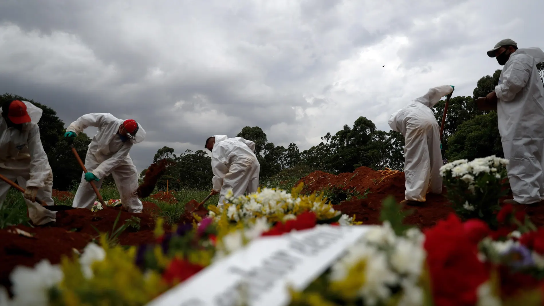 AME9644. SAO PAULO (BRASIL), 04/03/2021.- Personas se encargan de realizar el entierro de una víctima de la covid-19 hoy en el cementerio Viola Formosa en Sao Paulo (Brasil). Brasil, uno de los países más afectados del mundo por la pandemia, registró 1.699 muertes por covid-19 en las últimas 24 horas, lo que equivale a un fallecido cada 50 segundos, según informó este jueves el Gobierno. EFE/Fernando Bizerra Jr