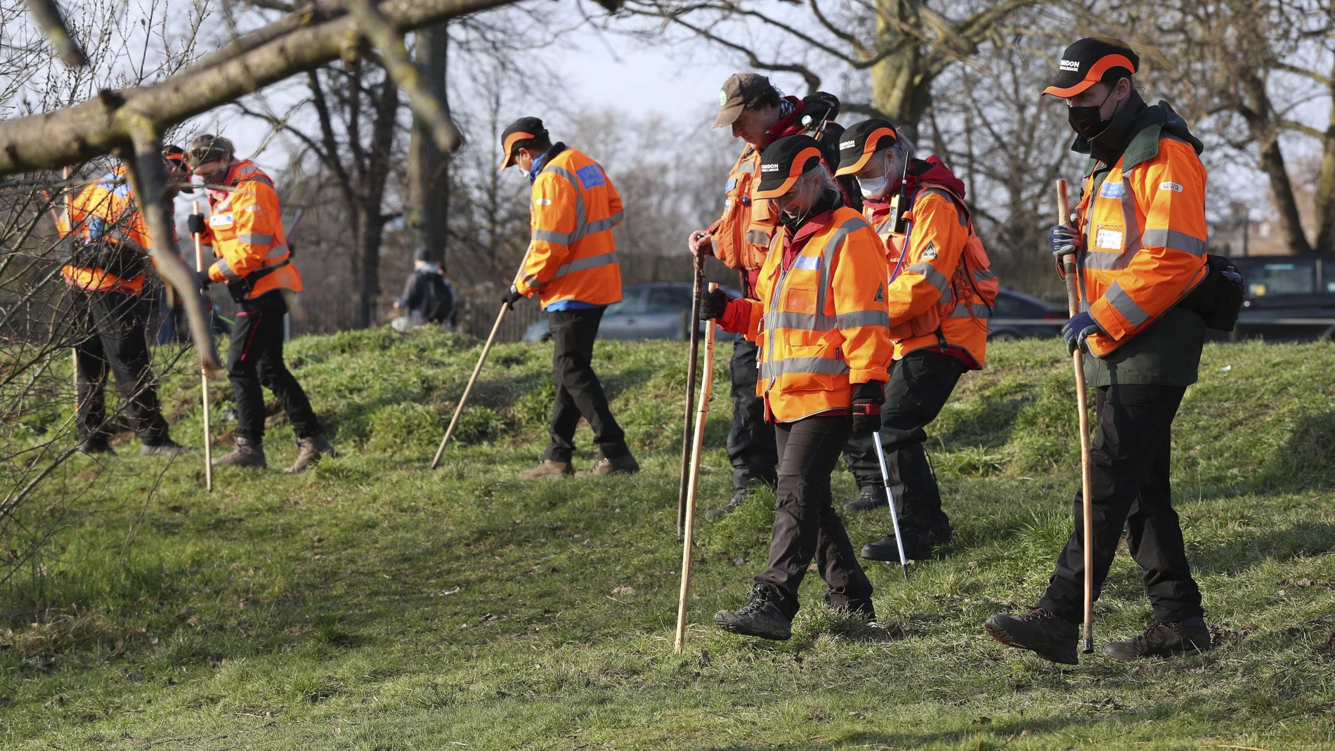 A search team near Eagle Pond on Clapham Common Sunday March 7, 2021, search for traces connected to missing 33-year old woman Sarah Everard, who has been missing since Wednesday. Everard left a friend's house in Clapham, south London, on Wednesday evening to walk home has not been seen or heard from since. (Jonathan Brady/PA via AP)