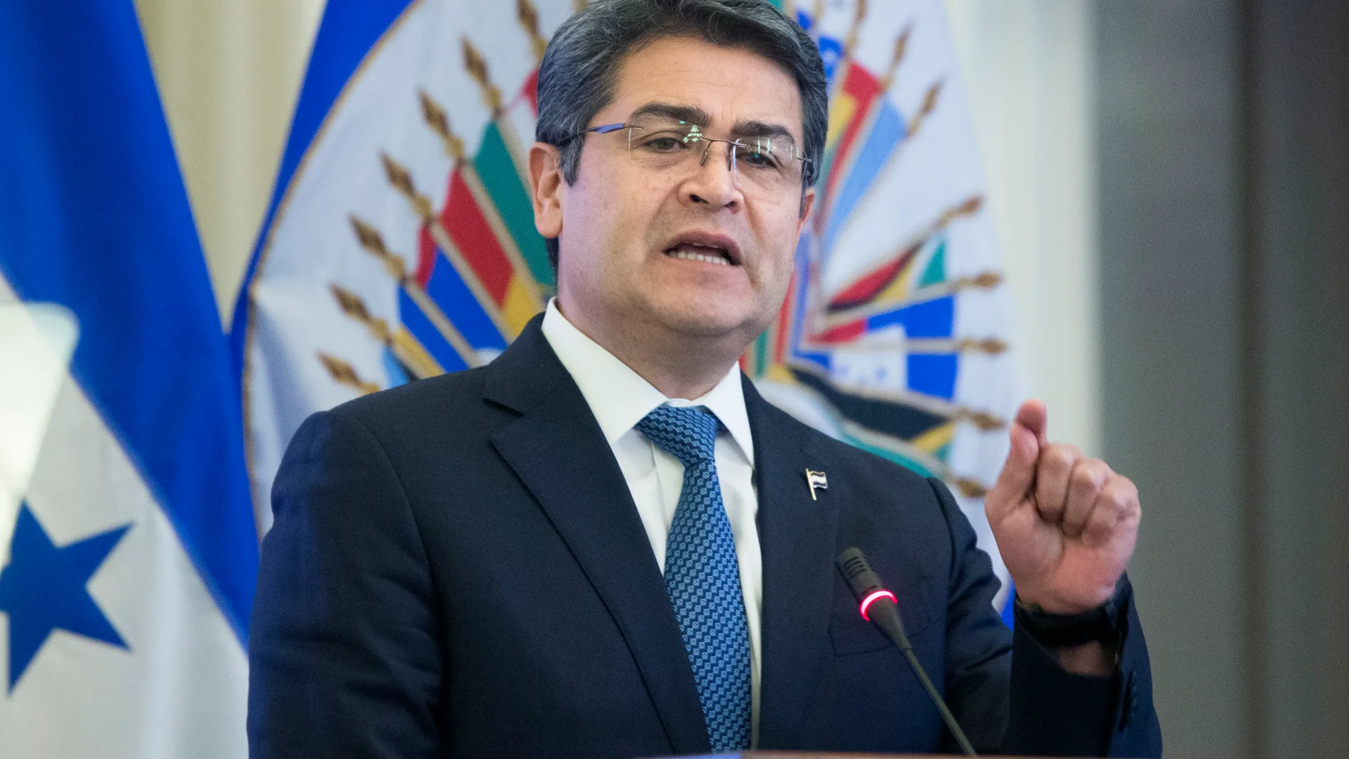 Washington (United States), 28/02/2019.- (FILE) President of Honduras Juan Orlando Hernandez delivers remarks during an official meeting hosted by the Permanent Council of the Organization of American States (OAS), at the OAS in Washington, DC, USA, 28 February 2019 (reissued 09 March 2021). The US federal prosecutor's office opened the trial on 09 March 2021 against the alleged Honduran drug trafficker Geovanny Fuentes Ramirez, assuring that he collaborated for years with the current Honduran president, Juan Orlando Hernandez, and describing Honduras as a 'narco-state.' (Abierto, Estados Unidos) EFE/EPA/MICHAEL REYNOLDS *** Local Caption *** 55021206