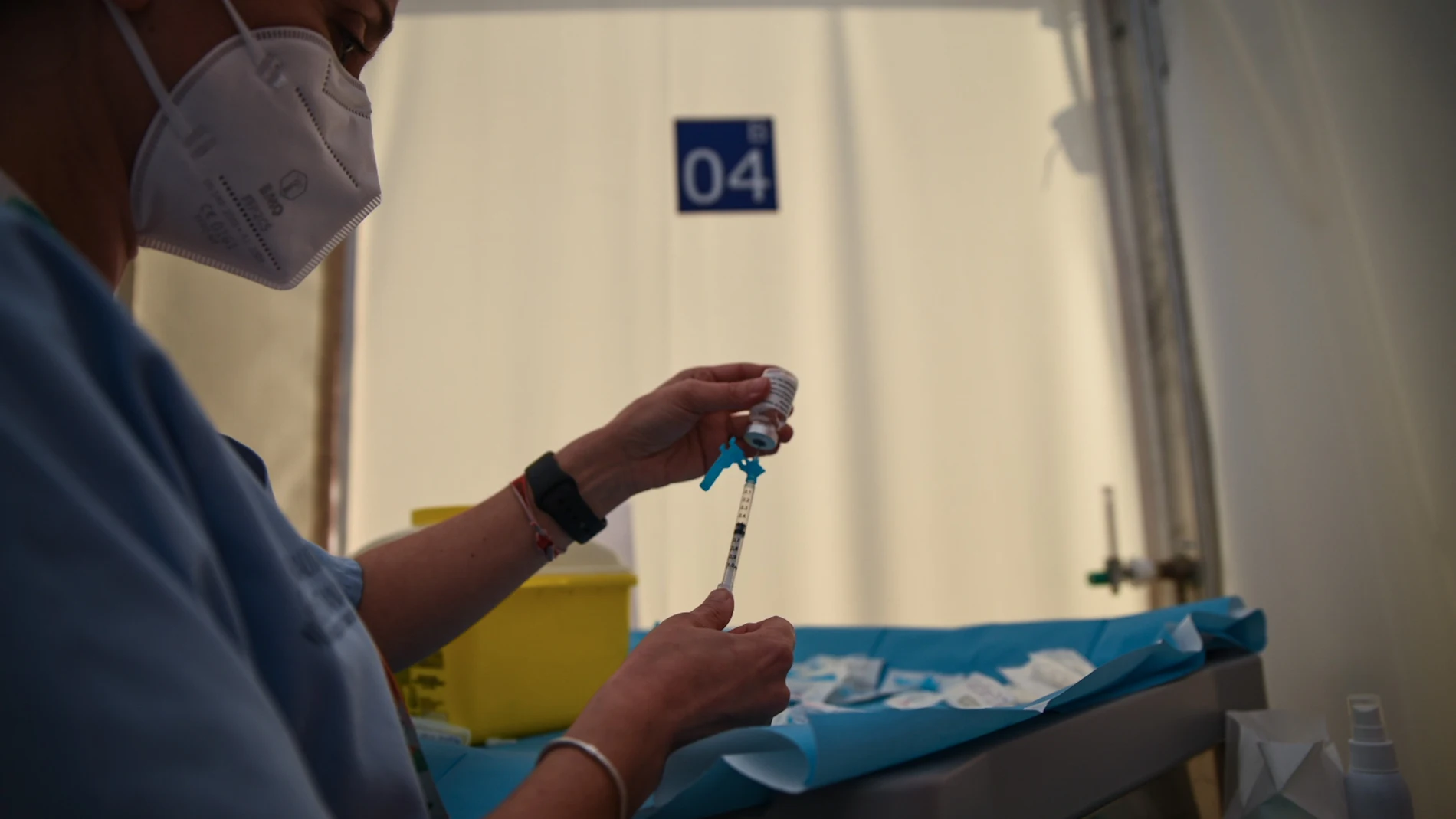 Una profesional sanitaria sostiene una jeringuilla y un vial con la vacuna contra la Covid-19 de AstraZeneca en el Hospital de campaña de La Fe, en Valencia.