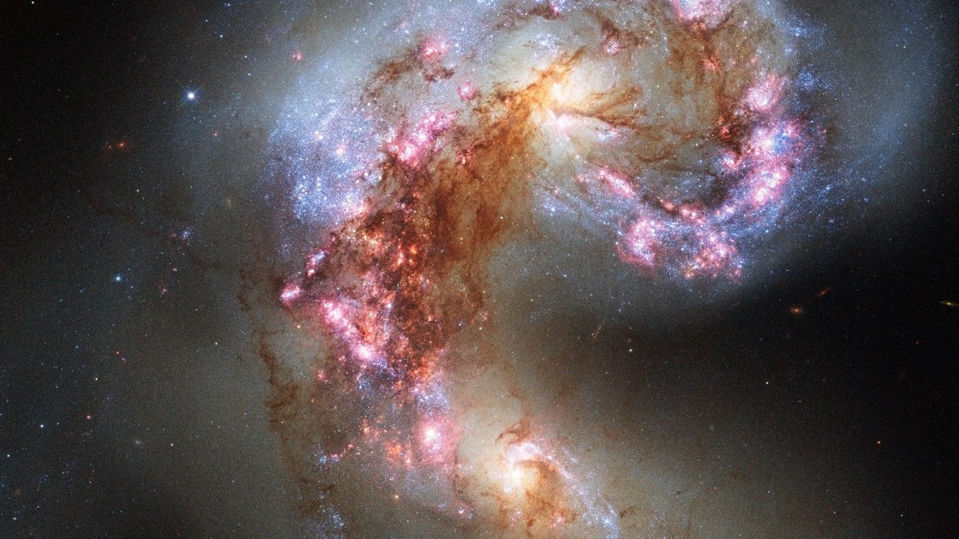 Imagen de las galaxias Antennae tomada por la NASA mediante el telescopio espacial Hubble. Estas dos galaxias intercambian materia a más de 70 millones de años luz de distancia, por lo que viajar hasta ellas es implantable aunque pudiéramos movernos a la velocidad de la luz. La luz que nos llega de ellas escapó de sus estrellas cuando los dinosaurios todavía dominaban la Tierra.