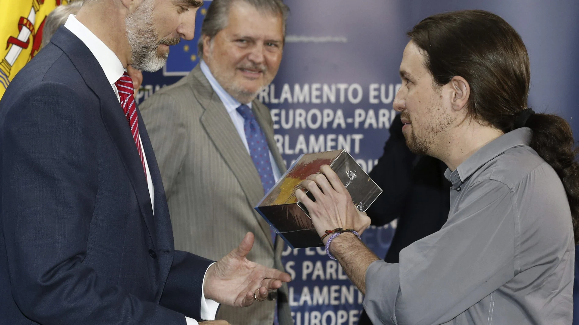 El líder de Podemos, Pablo Iglesias, (dch), saluda al rey Felipe VI y le entrega una colección de 'Juego de tronos' durante la visita del monarca a la Eurocámara en Bruselas