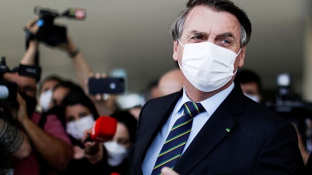 FILE PHOTO: Brazil's President Jair Bolsonaro is seen after a meeting with Brazil's Lower House Arthur Lira at the Planalto Palace, in Brasilia, Brazil, March 25, 2021. REUTERS/Ueslei Marcelino/File Photo