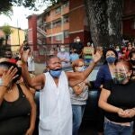 Catholic faithful react as the Popemobile carrying the statue of The Nazarene of St. Paul drives past during Holy Week celebrations in the neighbourhood Catia, in Caracas, Venezuela March 31, 2021. REUTERS/Leonardo Fernandez Viloria NO RESALES. NO ARCHIVES