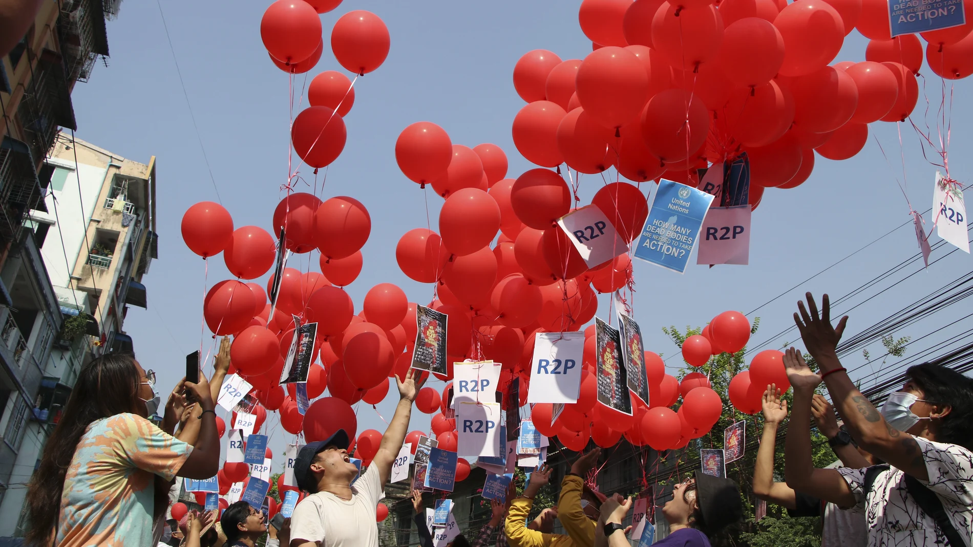 FILE - In this March 22, 2021, file photo, anti-coup protesters release red balloons with notes calling for foreign intervention to help them in Yangon, Myanmar. Many in Myanmar have found a safer, more substantive way to protest the countryâ€™s military coup. Instead of facing down heavily armed soldiers from behind flimsy barricades, they're holding online rummage sales using sites like Facebook. (AP Photo, File)