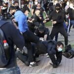 Radicales patean a un policía en el suelo y sin casco durante el mitin de Vox en la Plaza Roja de Vallecas, el miércoles z