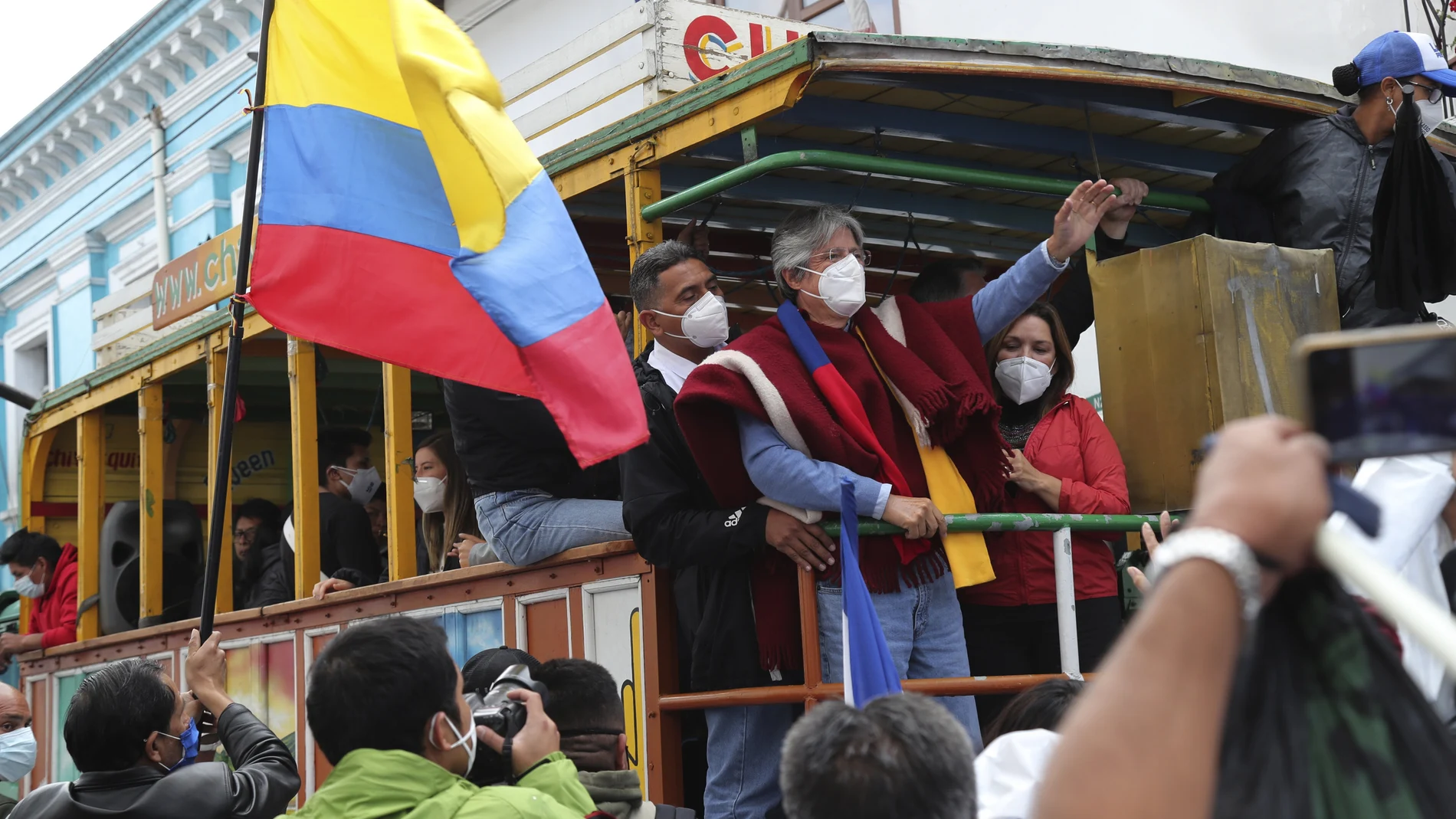 Former banker Guillermo Lasso, presidential candidate for the CREO political party, and his wife Maria de Lourdes Alcivar greet supporters from a "Chiva," an old truck converted to carry tourists, during a rally ahead of Ecuador's runoff presidential election in Quito, Ecuador, Wednesday, April 7, 2021. (AP Photo/Dolores Ochoa)