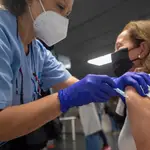 Una trabajadora sanitaria administra la primera dosis de la vacuna AstraZeneca contra el Covid-19 a una persona en el Wizink Center, en Madrid