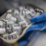 A nurse holds vials of AstraZeneca vaccine against COVID-19 during a vaccination campaign at WiZink indoor arena in Madrid, Spain, Friday, April 9, 2021. Madrid is expanding its mass COVID-19 vaccination program, with jabs being administered from Friday at the city's large WiZink indoor arena. Some 4,000 people between 60 and 65 years of age were due to receive the AstraZeneca vaccine there on the first day. (AP Photo/Manu Fernandez)