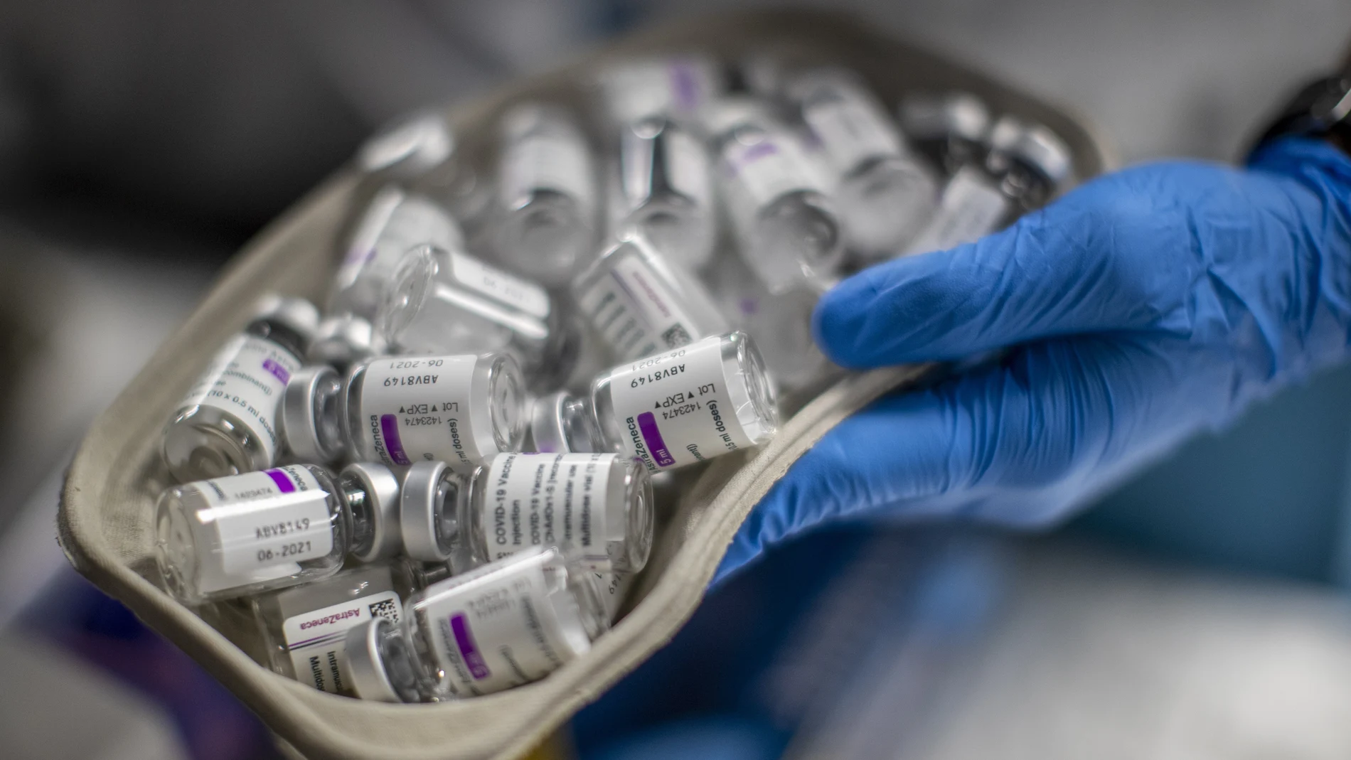 A nurse holds vials of AstraZeneca vaccine against COVID-19 during a vaccination campaign at WiZink indoor arena in Madrid, Spain, Friday, April 9, 2021. Madrid is expanding its mass COVID-19 vaccination program, with jabs being administered from Friday at the city's large WiZink indoor arena. Some 4,000 people between 60 and 65 years of age were due to receive the AstraZeneca vaccine there on the first day. (AP Photo/Manu Fernandez)