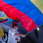 08 April 2021, Ecuador, Quito: Andres Arauz, the presidential candidate in Ecuador, waves a large national flag on stage at the end of his campaign. The runoff between leftist candidate Arauz and conservative banker Lasso is scheduled to take place on 11 April. Photo: Juan Diego Montenegro/dpa08/04/2021 ONLY FOR USE IN SPAIN