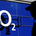 Un hombre pasa por delante de una tienda con el logo de O2