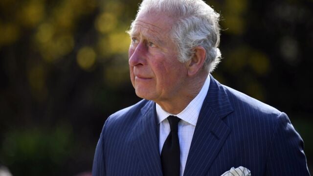 FILE - In this Thursday April 15, 2021 file photo, Britain's Prince Charles visits the gardens of Marlborough House, London, to look at the flowers and messages left by members of the public outside Buckingham Palace, following the death of Prince Philip. Buckingham Palace on Thursday, April 15, 2021 released the broad outlines of the program for Prince Philipâ€™s funeral, revealing that William and Harryâ€™s cousin Peter Phillips would walk between the princes as they escort the coffin to St. Georgeâ€™s Chapel at Windsor Palace. Prince Charles, the heir to the throne, together with his sister, Princess Anne, will lead the 15-member procession. (Jeremy Selwyn/Pool via AP, file)