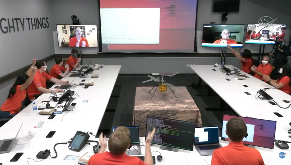 Pasadena (United States), 19/04/2021.- A handout video still taken from a livestream by NASA shows engineers celebrating after data downlinked from NASA's Ingenuity Helicopter suggested a successful first test flight on Mars, at the control room at NASA's Jet Propulsion Laboratory in Pasadena, California, USA, 19 April 2021. According to NASA, Ingenuity has successfully peformed a short flight on Mars, the first ever helicopter flight on another planet. A key objective for Perseverance's mission on Mars is astrobiology, including the search for signs of ancient microbial life. (Estados Unidos) EFE/EPA/NASA HANDOUT HANDOUT EDITORIAL USE ONLY/NO SALES