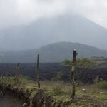 Shrouded by clouds and volcanic ash particles, lava flows down the slopes of the Pacaya Volcano, near El Patrocinio village in San Vicente Pacaya, Guatemala, Wednesday, April 21, 2021. The 8,373-foot volcano, just 30 miles south of Guatemalaâ€™s capital, has been active since early February. (AP Photo/Moises Castillo)