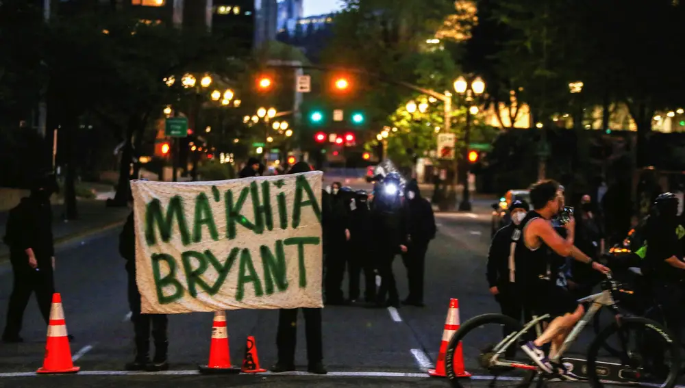 Protesters hold a sign with the name of Ma'Khia Bryant, who was fatally shot by a police officer in Columbus, Ohio, as they gather on a road after the verdict in the trial of former Minneapolis police officer Derek Chauvin, found guilty of the death of George Floyd, in Portland, Oregon, U.S., April 20, 2021. REUTERS/Alisha Jucevic