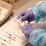 Un empleado sanitario sostiene una de las vacunas de Pfizer contra el Covid-19