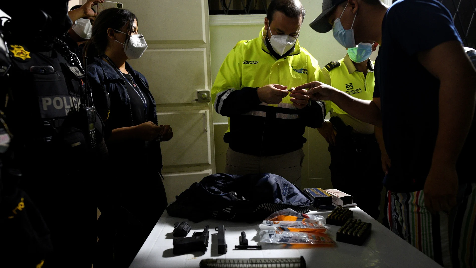 A policeman checks the ID of a man during a police operation to tackle COVID-19 restrictions violations, amid a rise in coronavirus disease cases and deaths, in Guayaquil, Ecuador May 1, 2021. Picture taken May 1, 2021. REUTERS/Santiago Arcos