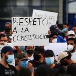 People hold signs reading "Respect for the constitution", as they protest against the removal of Supreme Court judges and the Attorney General by Salvadoran congress, in San Salvador, El Salvador, May 2, 2021. REUTERS/ Jose Cabezas
