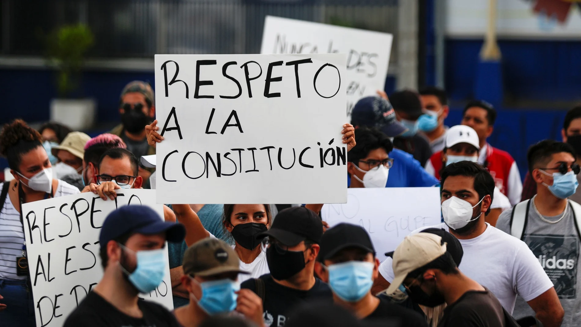 People hold signs reading "Respect for the constitution", as they protest against the removal of Supreme Court judges and the Attorney General by Salvadoran congress, in San Salvador, El Salvador, May 2, 2021. REUTERS/ Jose Cabezas