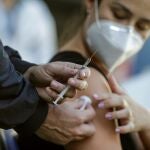 Una mujer que lleva una máscara protectora, fotografiada después de recibir una dosis de la vacuna de Pfizer/BioNTech contra la covid-19.. EFE/André Coelho