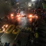 04 May 2021, Colombia, Bogota: Protesters write 'SOS' on the street during a protest as part of a national strike against the government's tax reform bill. Photo: Daniel Garzon Herazo/ZUMA Wire/dpaDaniel Garzon Herazo/ZUMA Wire/d / DPA04/05/2021 ONLY FOR USE IN SPAIN