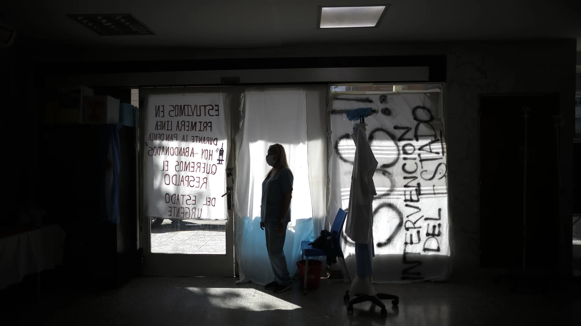 Nurse Lidia Del Valle stands inside San Andres Clinic which has been occupied by its former workers since it closed at the start of the year following the death of the hospital's director and owner in Caseros, Argentina, Friday, April 30, 2021. While the pandemic has swelled the need for hospital beds, many private clinics say they're struggling to survive, citing the pandemic having pushed away many non-COVID patients and losing money on coronavirus sufferers because the government insurance program doesn't pay enough to meet costs. (AP Photo/Natacha Pisarenko)
