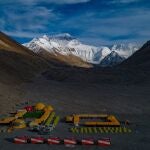 In this aerial photo released by Xinhua News Agency, the Mount Qomolangma, also known as Mount Everest, base camp is seen on May 25, 2020. China will draw a â€œseparation lineâ€ atop Mount Everest to prevent the coronavirus from being spread by climbers ascending from Nepal's side of the mountain, Chinese state media reported Monday, May 10, 2010. (Purbu Zhaxi/Xinhua via AP)