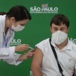 10 May 2021, Brazil, Sao Paulo: Victor Machado receives a shot of the AstraZeneca coronavirus (Covid-19) vaccine at the start of the priority vaccination program for people with Down syndrome in Sao Paulo. Photo: Paulo Lopes/ZUMA Wire/dpa10/05/2021 ONLY FOR USE IN SPAIN