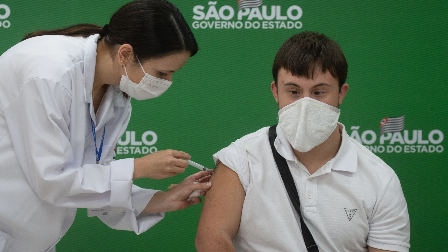 10 May 2021, Brazil, Sao Paulo: Victor Machado receives a shot of the AstraZeneca coronavirus (Covid-19) vaccine at the start of the priority vaccination program for people with Down syndrome in Sao Paulo. Photo: Paulo Lopes/ZUMA Wire/dpa10/05/2021 ONLY FOR USE IN SPAIN