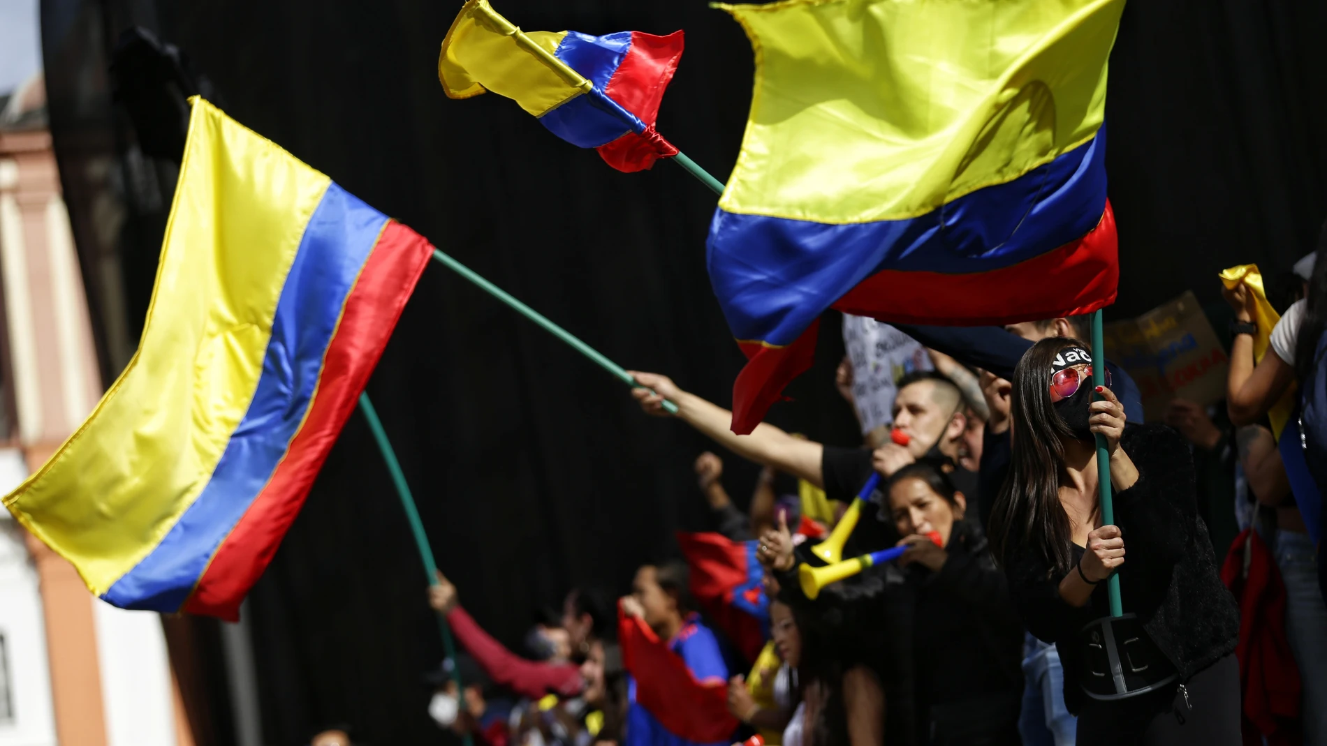 12 May 2021, Colombia, Bogota: Demonstrators wave Colombian flags during a protest against the government of Colombian President Ivan Duque Marquez. Photo: Sergio Acero/colprensa/dpa12/05/2021 ONLY FOR USE IN SPAIN