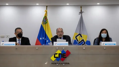 AME7630. CARACAS (VENEZUELA), 13/05/2021.- El presidente del Consejo Nacional Electoral (CNE) de Venezuela, Pedro Calzadilla (c), ofrece declaraciones a los medios de comunicación, junto a los rectores electorales Enrique Márquez (i) y Tania D'amelio (d) hoy, en Caracas (Venezuela). Las elecciones locales y regionales de Venezuela se celebrarán el próximo 21 de noviembre, mientras que la campaña electoral comenzará el 28 de octubre, informó este jueves Calzadilla. EFE/ Rayner Peña