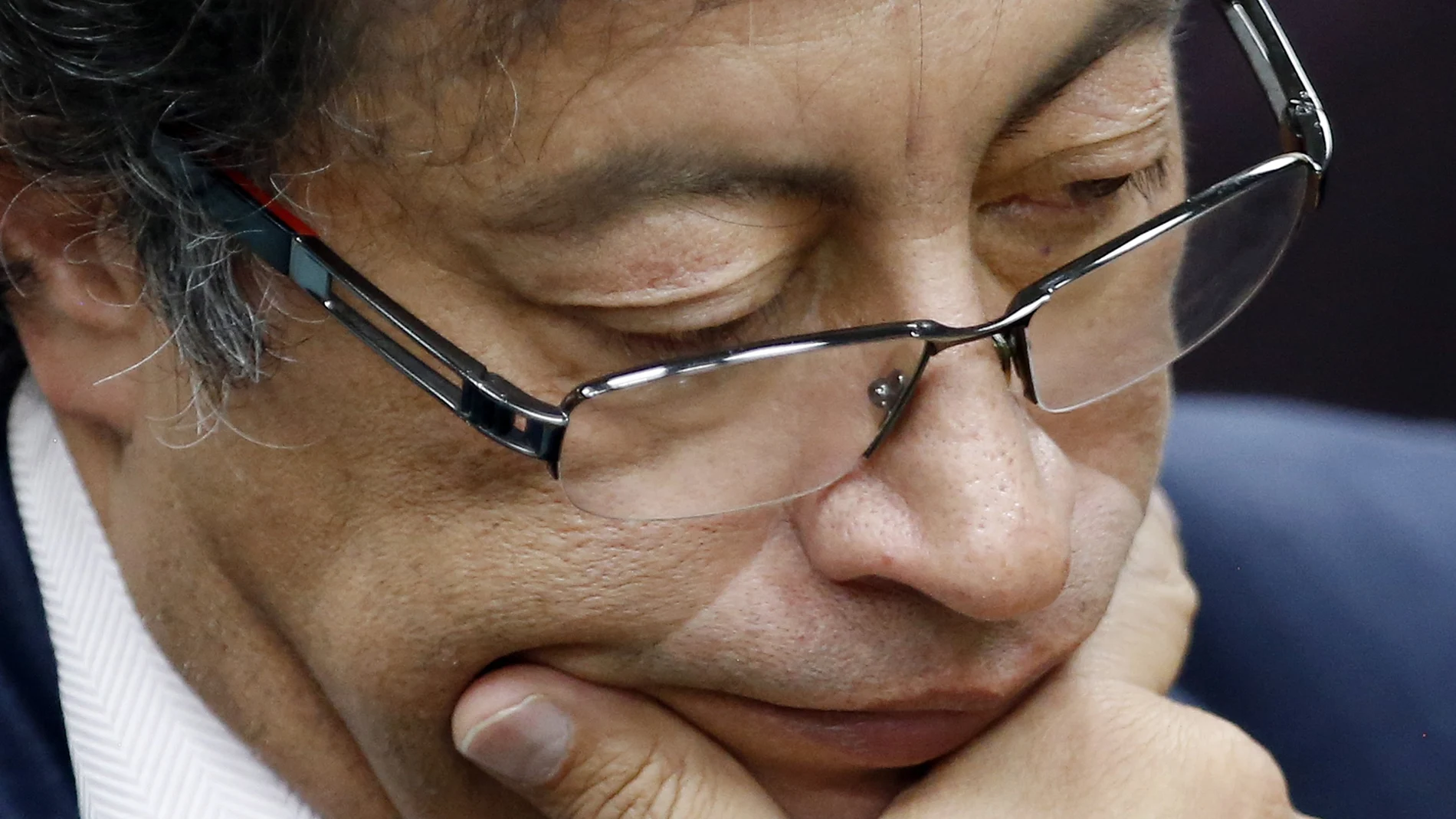 FILE - In this Dec. 4, 2018 file photo, Senator Gustavo Petro pauses during an interview at a local radio station in Bogota, Colombia. The former presidential candidate has adopted a low-key approach during the anti-government protests that started in late April 2021 ahead of his third run for Colombia’s presidency.  AP Photo/Fernando Vergara, File)
