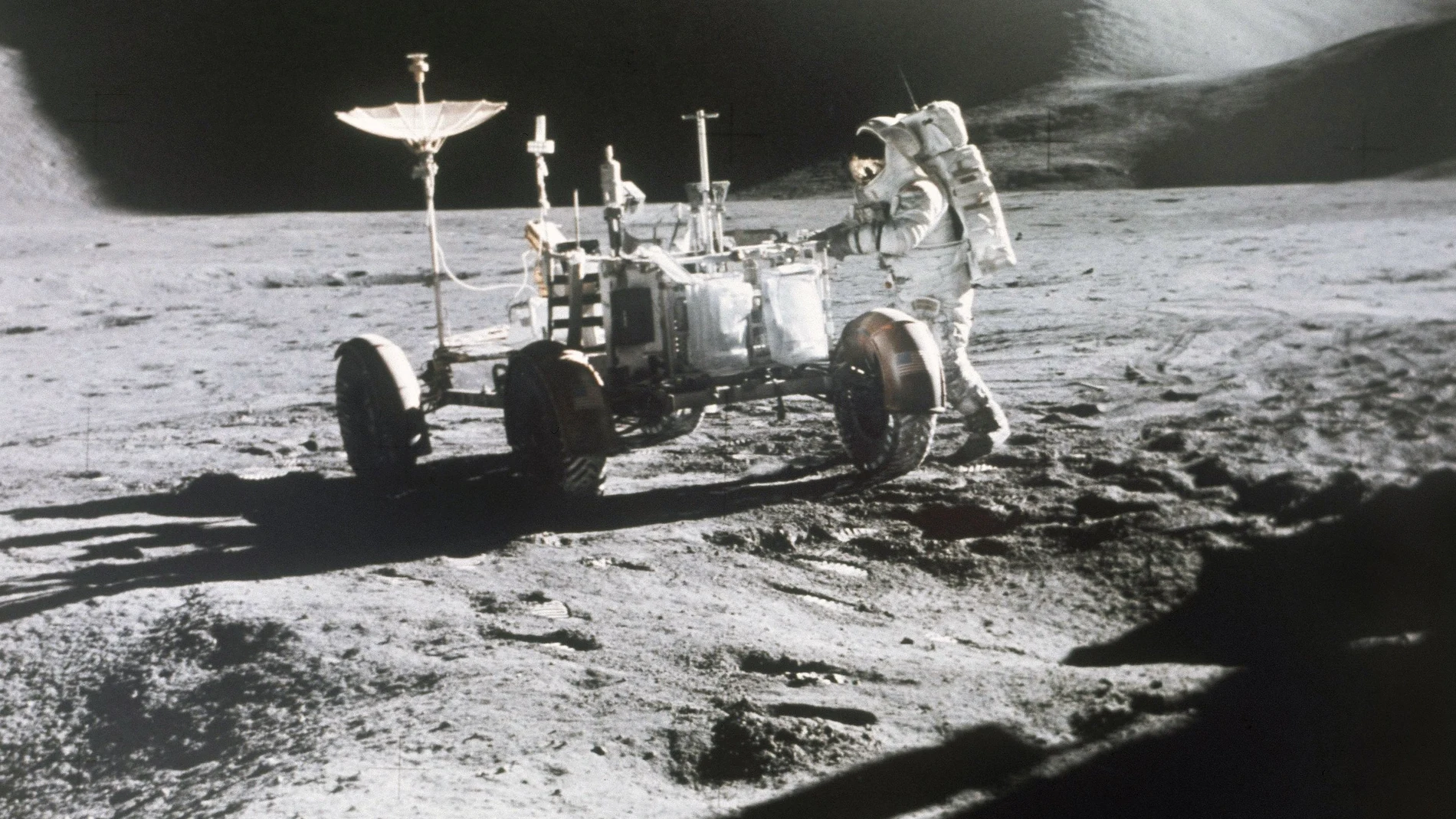 FILE - In this 1971 photo made available by NASA, astronaut James Irwin stands next to a rover on the surface of the moon. On Wednesday, May 26, 2021, Lockheed Martin and General Motors announced that they would combine their technological and manufacturing expertise to build the electric vehicles for NASAâ€™s Artemis program, named after the twin sister of Apollo in Greek mythology. (NASA via AP, File)