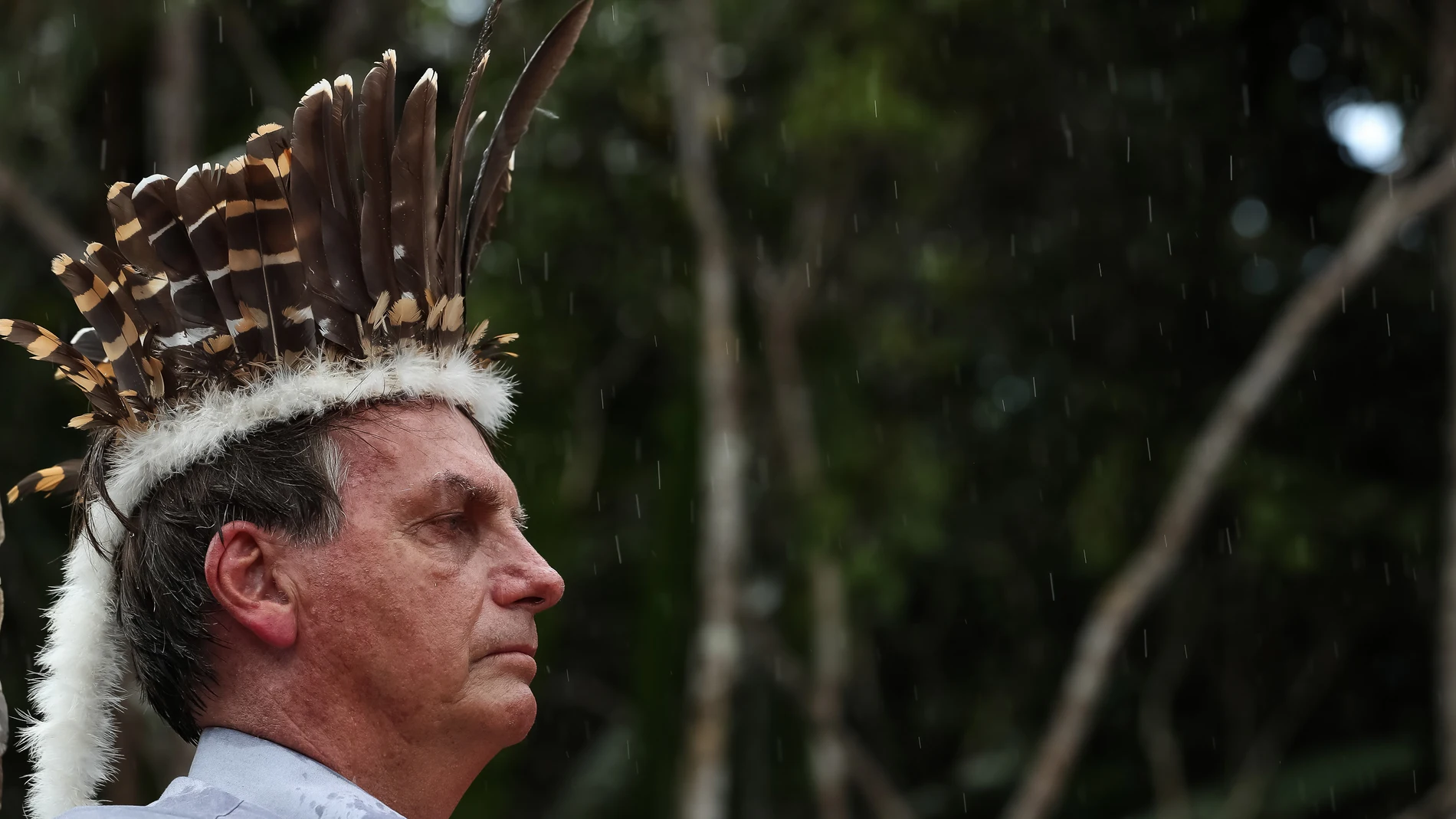 HANDOUT - 27 May 2021, Brazil, Sao Gabriel da Cachoeira: Brazilian President Jair Bolsonaro wears a traditional feather hat while attending the inauguration of the Rodrigo e Cibele wooden bridge with indigenous people in Sao Gabriel da Cachoeira. Photo: Marcos Correa/Brazilian Presidency /dpa - ATTENTION: editorial use only and only if the credit mentioned above is referenced in fullMarcos Correa/Brazilian Presiden / DPA27/05/2021 ONLY FOR USE IN SPAIN