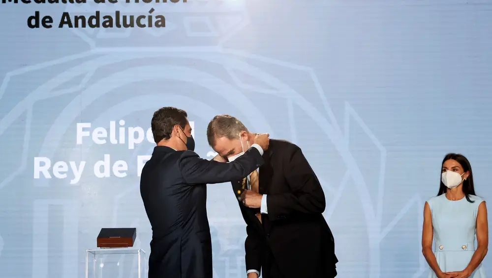 El rey Felipe VI recibe la primera Medalla de Honor de Andalucía de manos del presidente andaluz, Juanma Moreno (i), este lunes en el Palacio de San Telmo de Sevilla. EFE/Casa Real/Francisco Gómez