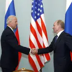 FILE - In this March 10, 2011 file photo, then U.S. Vice President Joe Biden, left, shakes hands with Russian Prime Minister Vladimir Putin in Moscow. (AP Photo/Alexander Zemlianichenko)