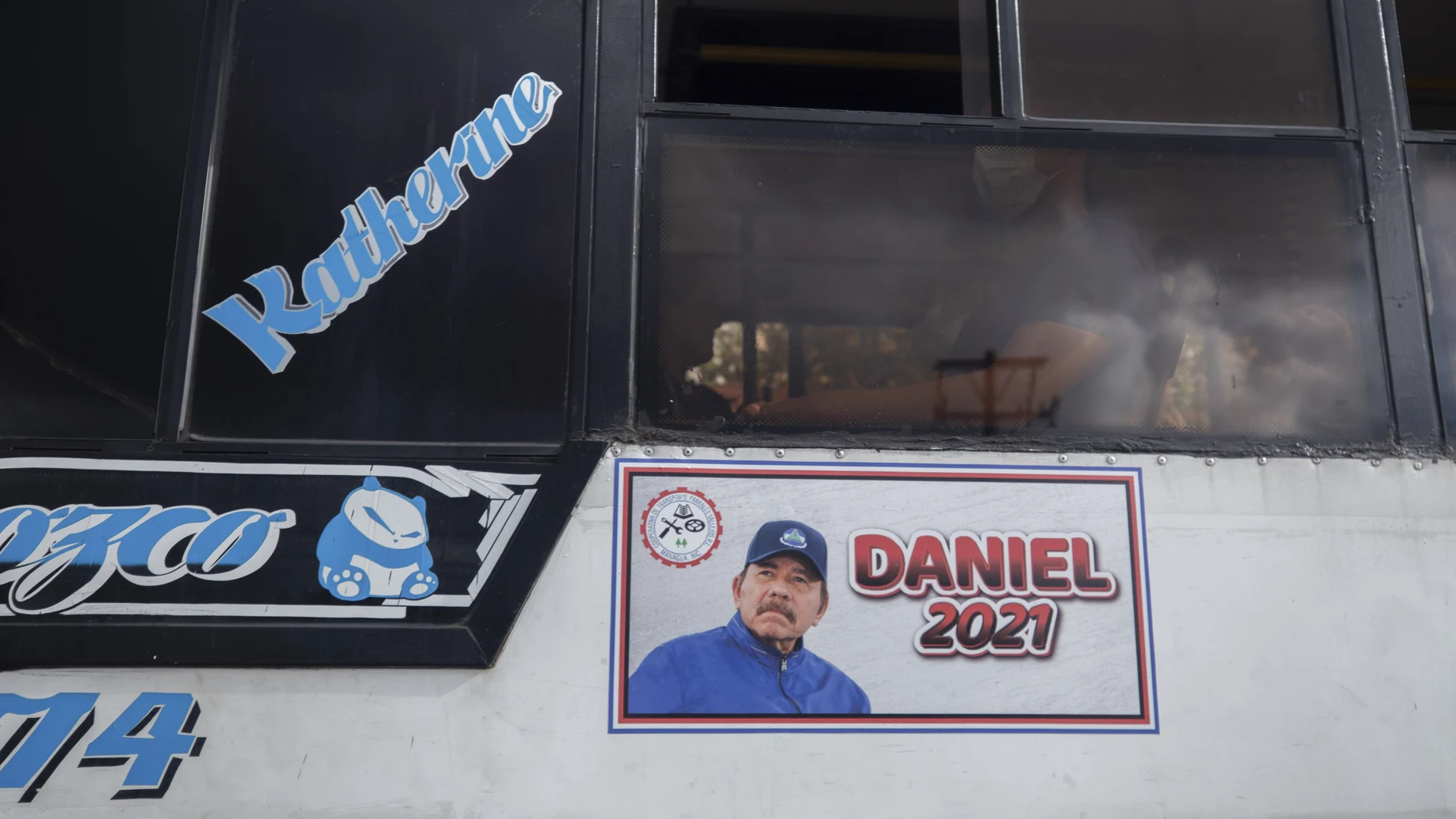 A poster promotes presidential candiate and current President Daniel Ortega on the side of a bus, in Managua, Nicaragua, Thursday, June 17, 2021. In recent weeks, Nicaragua President Daniel Ortega's government has rounded up 13 opposition leaders, including four presidential challengers for the Nov. 7 elections. They face allegations ranging from money laundering to crimes against the state. (AP Photo/Miguel Andres)