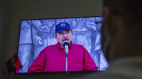A man watches a televised national address by Nicaraguan President Daniel Ortega, at his home in Managua, Nicaragua, Wednesday, June 23, 2021. The president of the Inter-American Commission on Human Rights Antonia Urrejola says that Nicaragua has entered a new phase of repression with at least 20 opposition figures arrested in recent weeks and "constant human rights violations." (AP Photo/Miguel Andres)