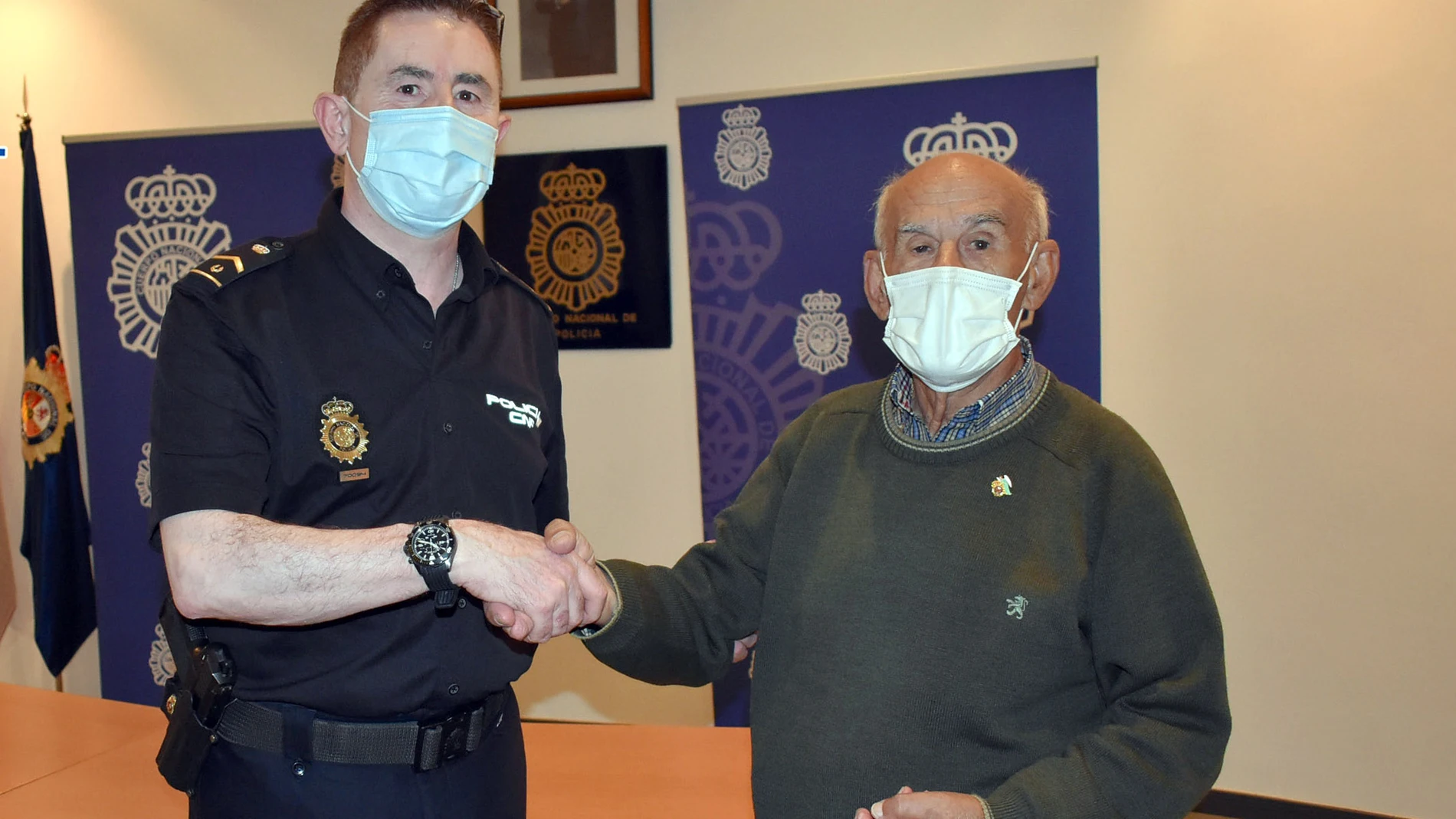 Un agente de la Policía Nacional de Palencia ayuda a un vecino