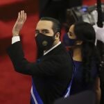 FILE - In this June 1, 2021 file photo, El Salvador's President Nayib Bukele waves during his annual address to the nation to congress, in San Salvador, El Salvador. Bukele's presidency so far is the story of one of Latin America's newest populist autocracies in the making: spending big to hand out goodies, branding opponents as enemies, raising the profile of the military.Â (AP Photo/Salvador Melendez, File)